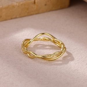 Detailed macro view of 18K gold plated irregular wave hollow ring with beaded texture