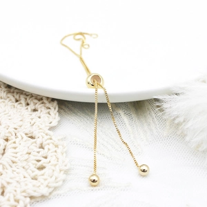 Detailed macro view of an 18K gold plated box chain with adjustable slider bead mechanism
