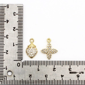 18K gold plated strawberry and four-leaf clover charms with cubic zirconia on a ruler