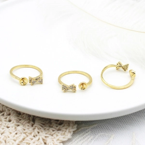 Adjustable 18K gold-plated bow ring setting with micro-pave cubic zirconia on ceramic tray