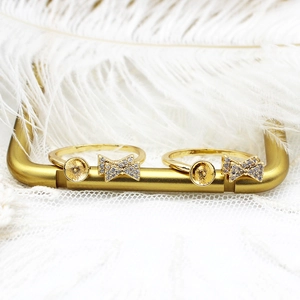 Detail of 18K gold plated DIY ring base with zircon bow and pearl setting on lace