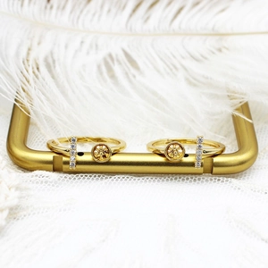 Detailed macro of 18K gold plated ring with bow tie design and shimmering zircon stones