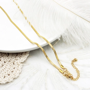 Detail van de 18K vergulde slangenketting met karabijnsluiting en verstelbare verlengketting
