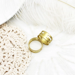 Matte gold minimalist geometric hollow rings set on soft white feather background