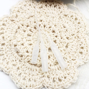 Three translucent silicone protective sleeves for jewelry tools on white lace background