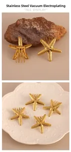 Macro detail of golden stainless steel starfish hair clip with vacuum plated texture