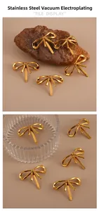 Detailed macro view of a 18K gold-plated stainless steel bow hair clip on a textured surface