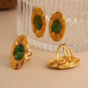 Vintage gold-tone jewelry set with green stone inlay featuring oval earrings and open rings