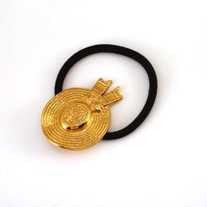 Elastic hair tie with golden straw hat metal charm featuring spiral texture and bow detail