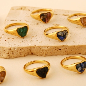 18K gold plated stainless steel heart rings with natural crushed stone inlay on travertine