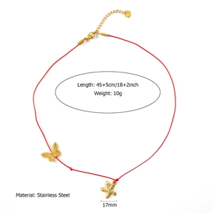 Detail view of handmade red cord necklace with stainless steel starfish and butterfly charms
