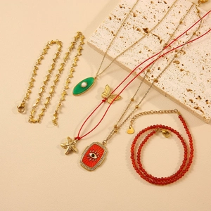 Fashion jewelry set with sea star pendant, evil eye necklace and golden dolphin bracelet