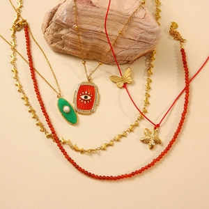Golden starfish and evil eye necklaces set with stainless steel pendants and red beads