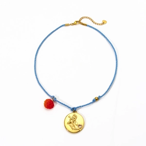 Handmade zodiac necklace with blue rope, gold pendant, and red berry charm detail