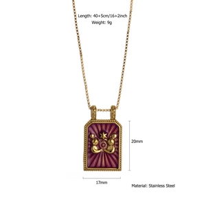 Macro detail of gold stainless steel necklace pendant with purple enamel and zodiac design