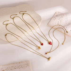 Golden stainless steel heart and strawberry pendant necklaces set with red enamel