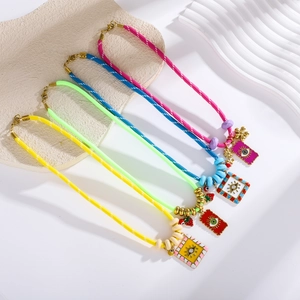 Detail showing four colorful woven cord necklaces with enamel evil eye pendants and beads