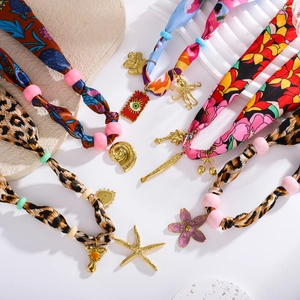 Detailed view of bohemian silk scarves necklaces with starfish and seashell charms