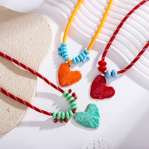 Bohemian cotton rope necklace featuring a large marble-textured stainless steel heart pendant