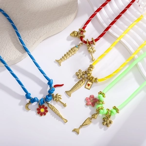 Kleurrijke boho touwketingen met gouden vis- en bloembedeltjes voor een strandzomerstijl