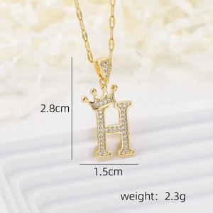 Macro view of gold crown letter H pendant with zircon stones including size specifications