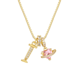 Detail view of gold box chain necklace featuring letter I and pink heart planet pendant
