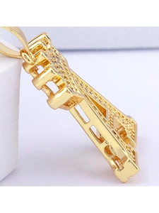 Macro side view of gold crown letter pendant featuring micro-set sparkling zircon stones