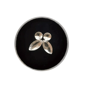 Marquise and round crystal tooth gems set in a circular black display case for beauty