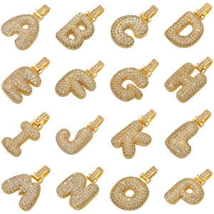 Macro detail of bubble letter pendants A-P featuring gold plating and micro-pave zircons