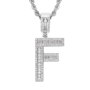 Macro shot of iced out silver letter F hip hop pendant with cubic zirconia on rope chain