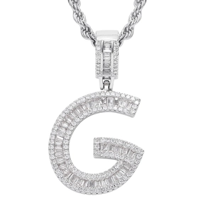 Macro detail of silver G letter pendant with baguette-cut zircons and twisted rope chain