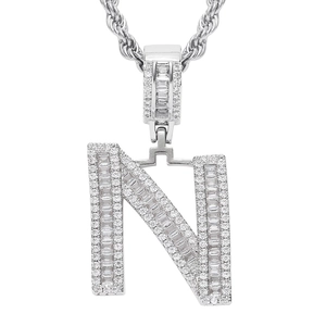 Macro detail of iced-out letter N pendant with baguette zircons and rope chain necklace