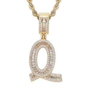 Macro view of gold-plated letter Q hip-hop pendant with shimmering pavé zircon stones