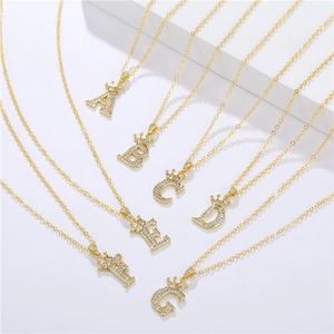 Detailed view of crown initial pendants A-G with shimmering zircons on gold necklaces