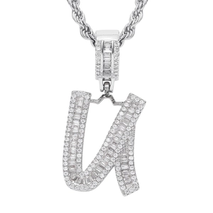 Macro shot of silver hip-hop pendant letter U with baguette and round cubic zirconia