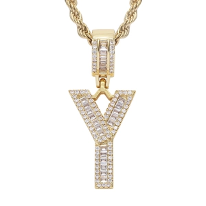Macro detail of gold plated hip hop letter Y pendant with iced out cubic zirconia stones