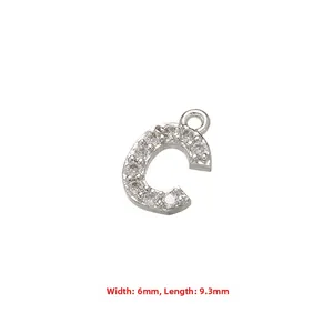 Macro shot of silver letter C pendant with micro-pave zircons and 6mm by 9.3mm size scale