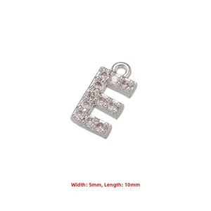 Macro shot of a silver letter E charm with cubic zirconia, measuring 10mm length and 5mm width