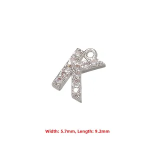Detailed macro shot of a silver-toned copper inlaid zircon letter K pendant accessory charm