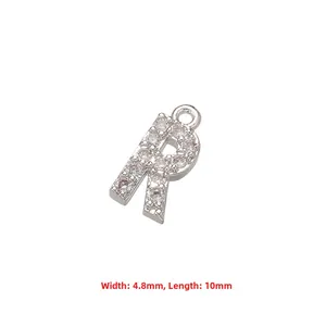 Macro detail of letter R pendant with cubic zirconia inlay measuring 4.8mm by 10mm