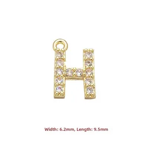 Detail view of gold letter H pendant with clear zircons, size 6.2mm width and 9.5mm length