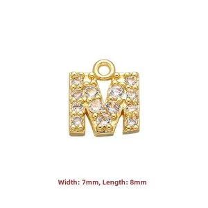 Macro shot of 7x8mm gold letter M pendant with cubic zirconia for jewelry making