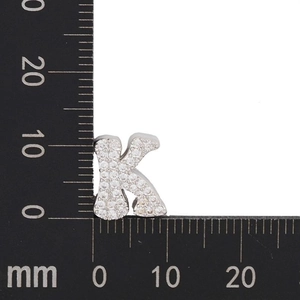 Detailed view of silver letter K pendant with cubic zirconia and size measurement scale