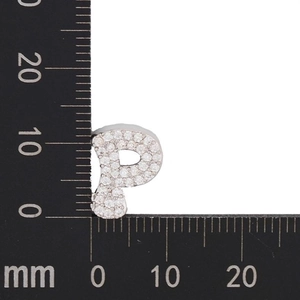 Macro view of crystal paved letter P pendant showing 12mm height and metal texture