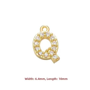 Macro view of gold-plated copper letter Q pendant with cubic zirconia, 10mm x 6.4mm