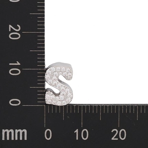 Macro shot of a silver letter S charm with zircon pave setting measuring 10mm in height