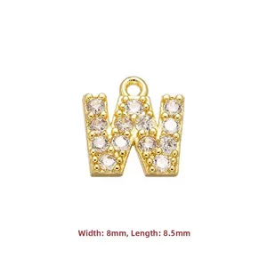 Macro detail of gold-plated copper letter W pendant with cubic zirconia stones 8mm size