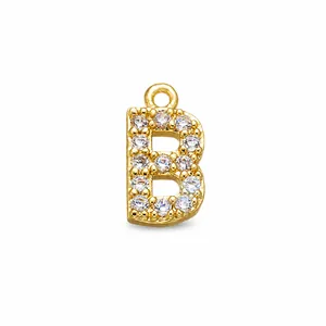 Detailed close-up of a gold-plated letter B pendant inlaid with white zircon stones