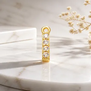 Macro view of gold jewelry connector piece with four inlaid sparkling cubic zirconias