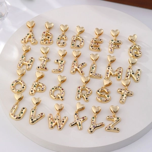 Golden A-Z heart-hook alphabet pendants with colorful zircon stones set on a round base